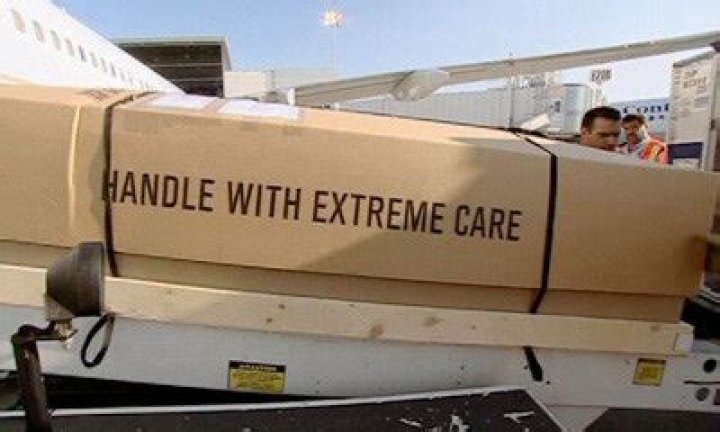 How is a dead body transported by plane?